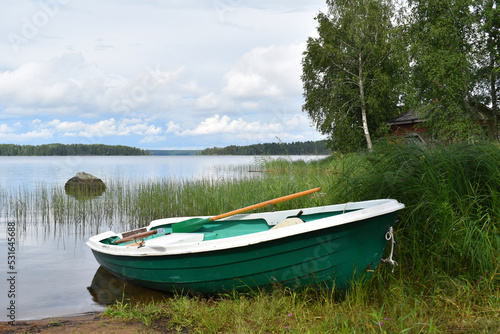 Fototapeta Naklejka Na Ścianę i Meble -  fishing boat on  water. rural peaceful landscape. fisherman's boat on the lake