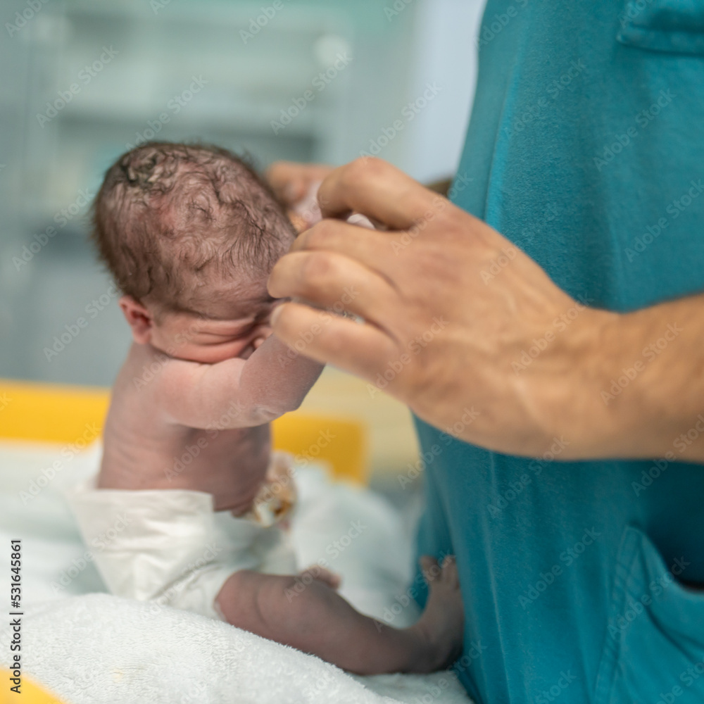 Fototapeta premium Newborn baby in hospital after birth Labor photo