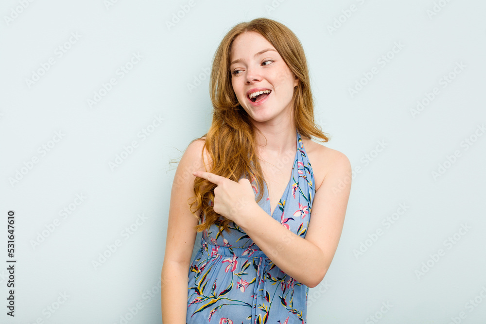 Young caucasian woman isolated on blue background looks aside smiling, cheerful and pleasant. Young caucasian woman isolated on blue background looks aside smiling, cheerful and pleasant.