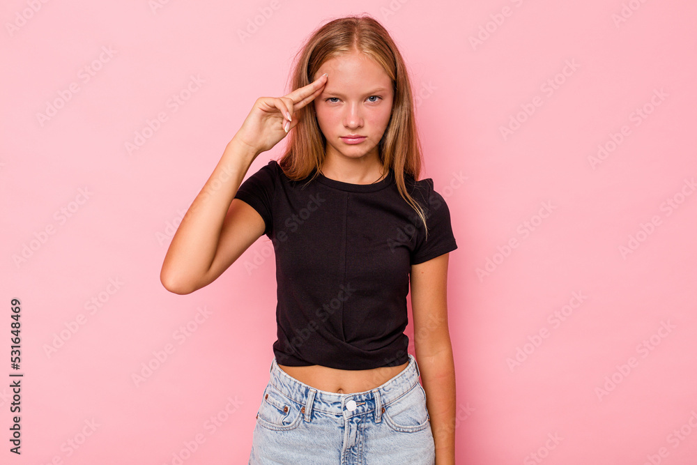 Caucasian teen girl isolated on pink background pointing temple with finger, thinking, focused on a task. Caucasian teen girl isolated on pink background pointing temple with finger, thinking, focused on a task.