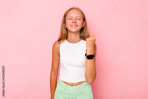 Caucasian teen girl isolated on pink background celebrating a victory  passion and enthusiasm  happy expression.