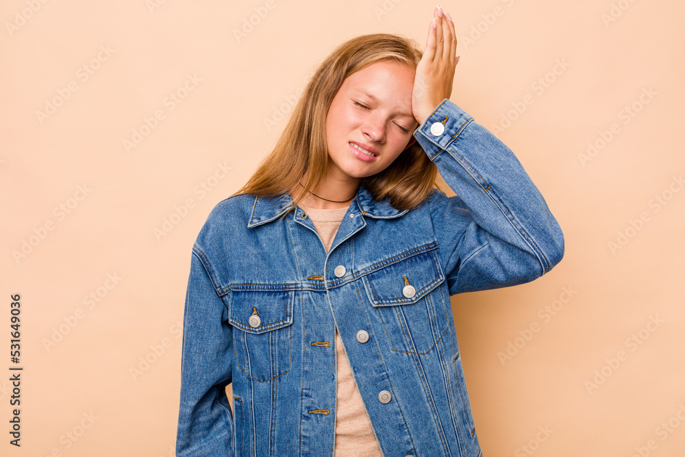 Caucasian teen girl isolated on beige background forgetting something, slapping forehead with palm and closing eyes. Caucasian teen girl isolated on beige background forgetting something, slapping forehead with palm and closing eyes.