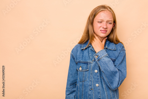 Caucasian teen girl isolated on beige background touching back of head, thinking and making a choice.