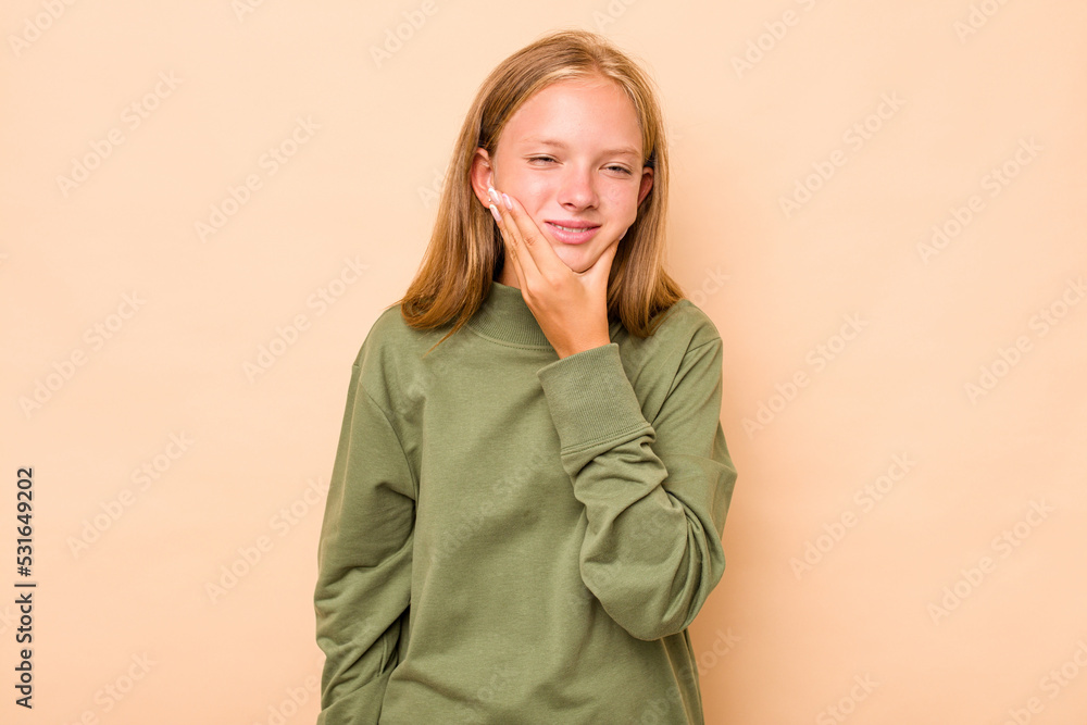 Caucasian teen girl isolated on beige background having a strong teeth pain, molar ache. Caucasian teen girl isolated on beige background having a strong teeth pain, molar ache.