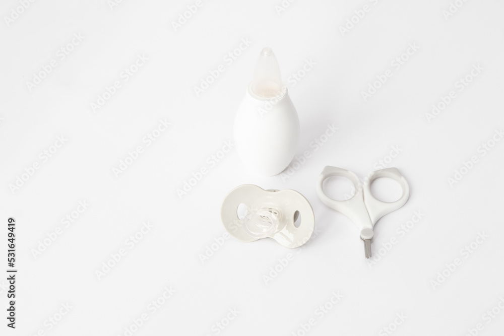 Child hygiene items. Gray and white baby care items on a white background