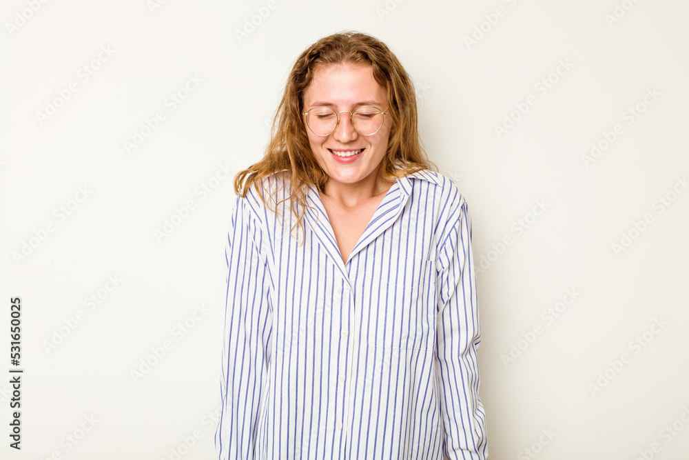 Young caucasian woman isolated on white background laughs and closes eyes, feels relaxed and happy. Young caucasian woman isolated on white background laughs and closes eyes, feels relaxed and happy.