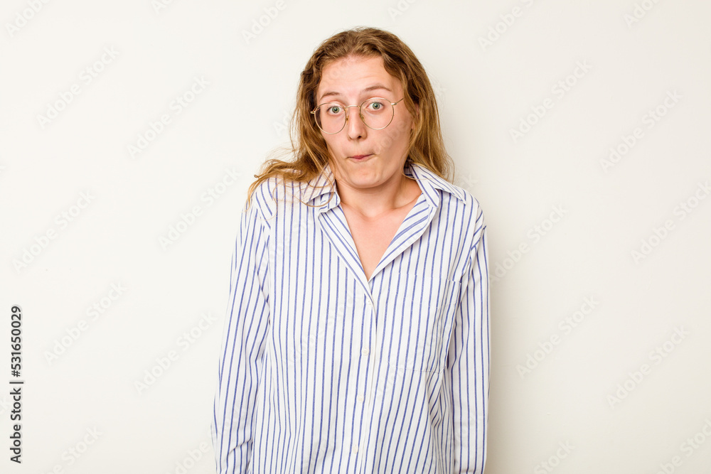 Young caucasian woman isolated on white background shrugs shoulders and open eyes confused. Young caucasian woman isolated on white background shrugs shoulders and open eyes confused.