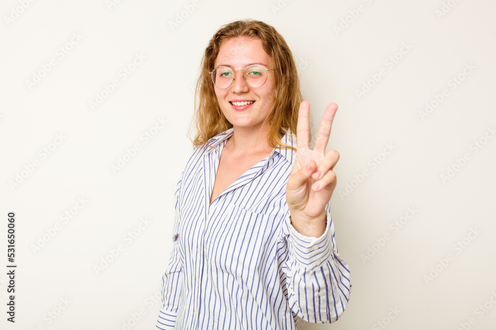Young caucasian woman isolated on white background showing victory sign and smiling broadly. Young caucasian woman isolated on white background showing victory sign and smiling broadly.