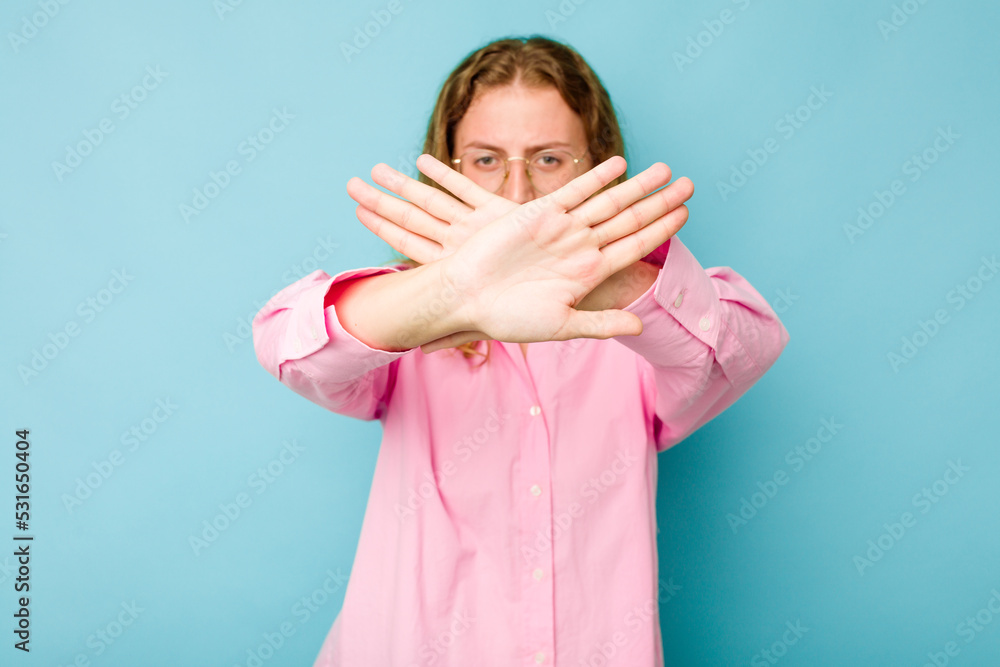 Young caucasian woman isolated on blue background doing a denial gesture Young caucasian woman isolated on blue background doing a denial gesture