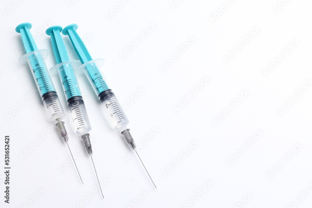 Medical syringe on a white background. A syringe for injection. The concept of health and beauty Medical syringe on a white background. A syringe for injection. The concept of health and beauty
