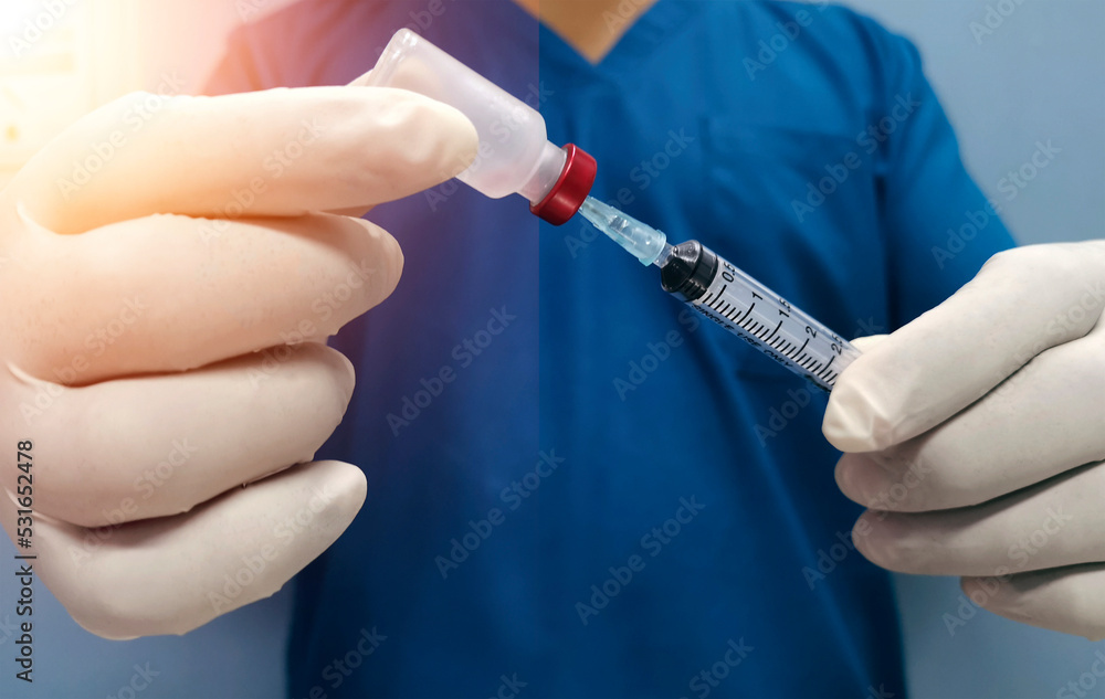 medical vaccination concept , doctor is prepareing vial of vaccine for injection medical vaccination concept , doctor is prepareing vial of vaccine for injection