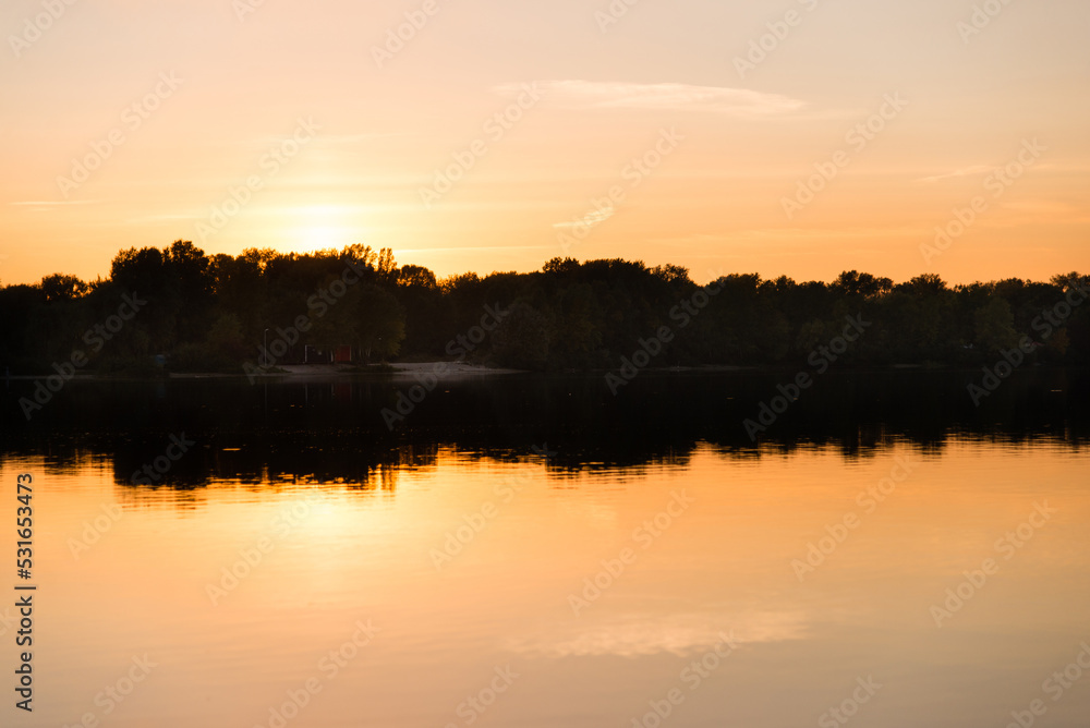 sunset over the river with reflection in the water	