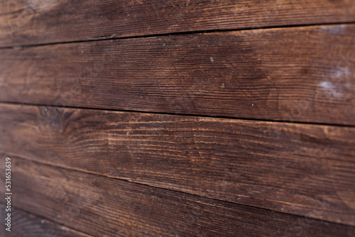 Vintage brown wood background texture with knots and nail holes. Old painted wood wall. Brown abstract background. Vintage wooden dark horizontal boards. Front view with copy space. Background for des