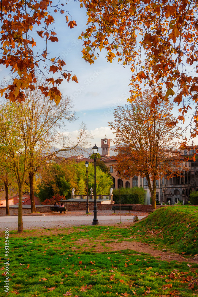 Autumn and foliage in Lucca. Romantic view of city walls park with autumnal leaves