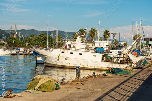 Fishing boats used for trawling (trawler), quayside with nets, ropes and moorage bollards. Port of La Spezia town, Gulf of La Spezia, Mediterranean sea, Liguria, Italy, Europe. photo