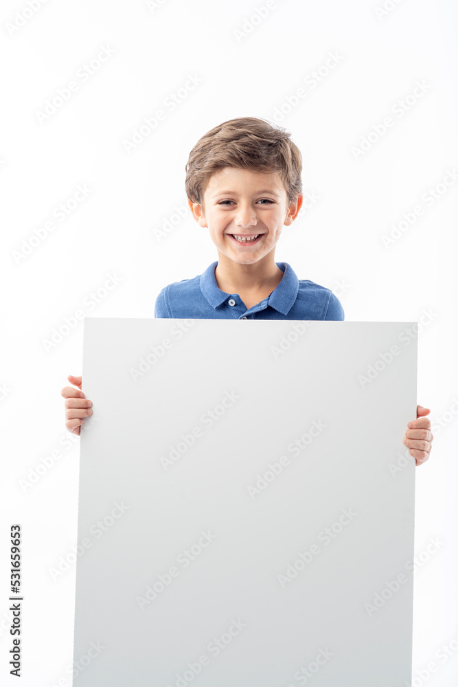 Funny child showing a white advertising poster with space for text. Funny child showing a white advertising poster with space for text.
