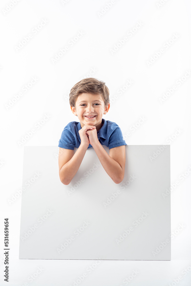 Funny child showing a white advertising poster with space for text. Funny child showing a white advertising poster with space for text.