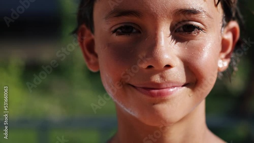 4k video Portrait of smiling handsome boy falling in swimming pool, child enjoying swimming in summer in pool. Vacation hotel concept.