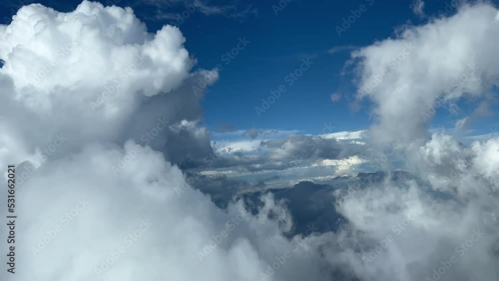 Stunning aerial view from a jet cockpit flying through cumulus clouds during the descent to Seville airport, Spain. Pilot point of view. 4K 60 FPS. Stunning aerial view from a jet cockpit flying through cumulus clouds during the descent to Seville airport, Spain. Pilot point of view. 4K 60 FPS.
