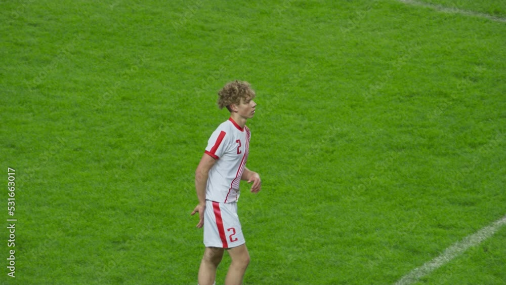 Professional Soccer Football Match Championship: White Team Player Running on the Field, Waiting for a Pass or Defense. Live Sport Broadcast Channel Television Playback. High Angle Following Tracking Professional Soccer Football Match Championship: White Team Player Running on the Field, Waiting for a Pass or Defense. Live Sport Broadcast Channel Television Playback. High Angle Following Tracking