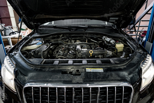 View of engine and other parts under the open hood of a car © fotofabrika
