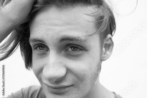 Young man clasps his head with his hands in despair
