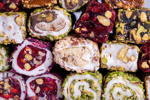 Assortment of Turkish delight with pistachio on a gray background. Mixed Turkish Delight. Close-up. local name fistikli fitil lokum photo