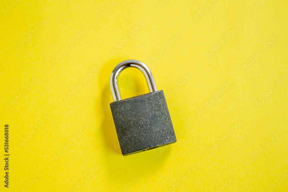 Top view of padlock isolated on yellow background. Top view of padlock isolated on yellow background.