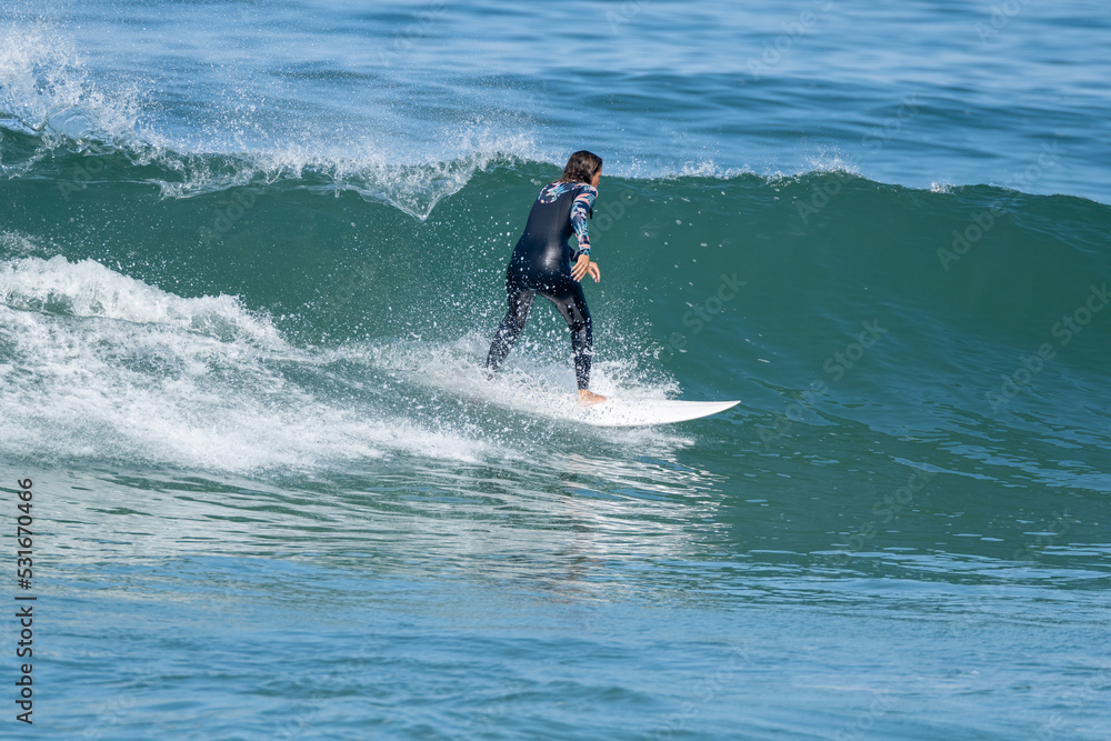 Surfer girl riding a wave