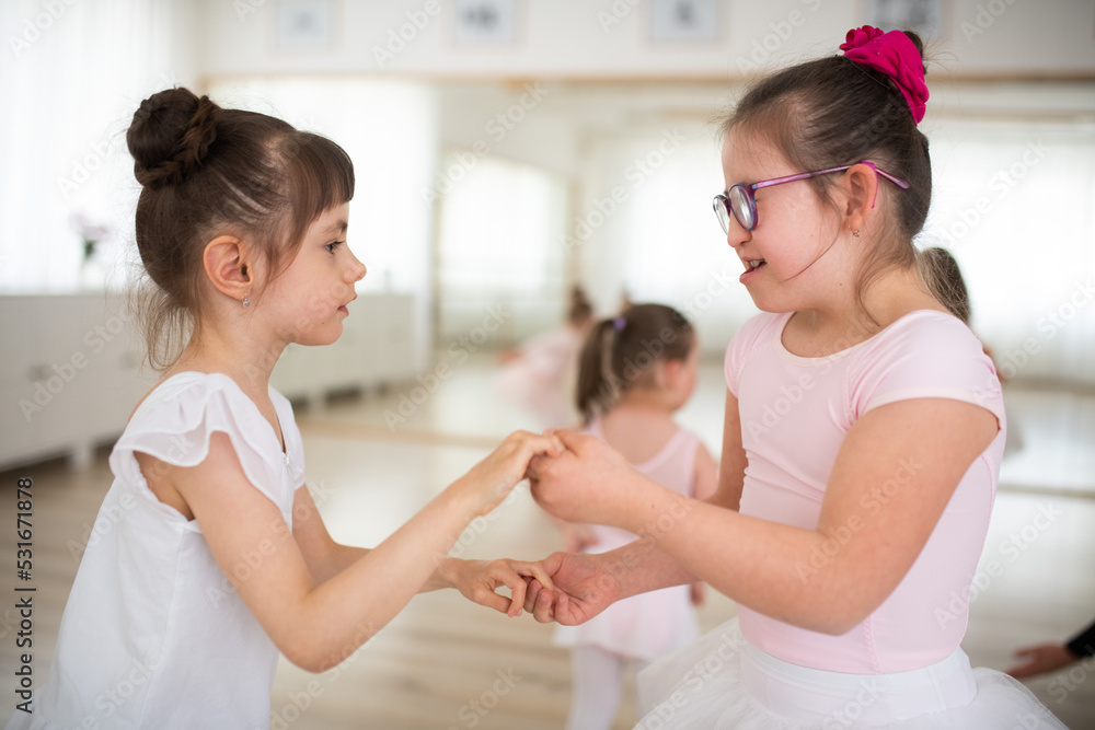 Little disabled girls dancing together in ballet school studio. Concept od integration and education disabled children. Little disabled girls dancing together in ballet school studio. Concept od integration and education disabled children.