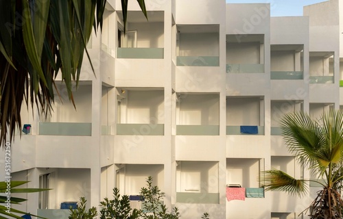 Facade with balconies of a white tourist hotel