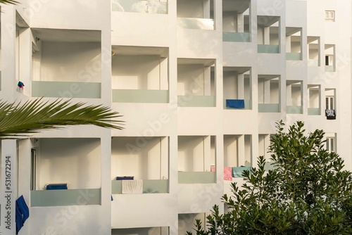 Facade with balconies of a white tourist hotel