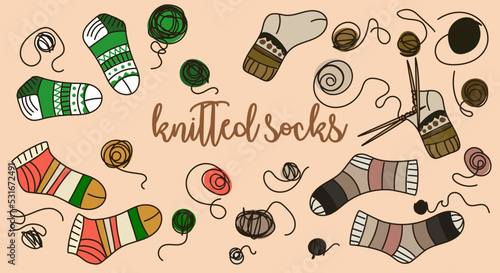 A set of multicolored knitted socks. Socks, balls and knitting needles. Warm socks for winter, hand-knitted. Suitable for using cute postcards from the production of knitted things. Printed products.
