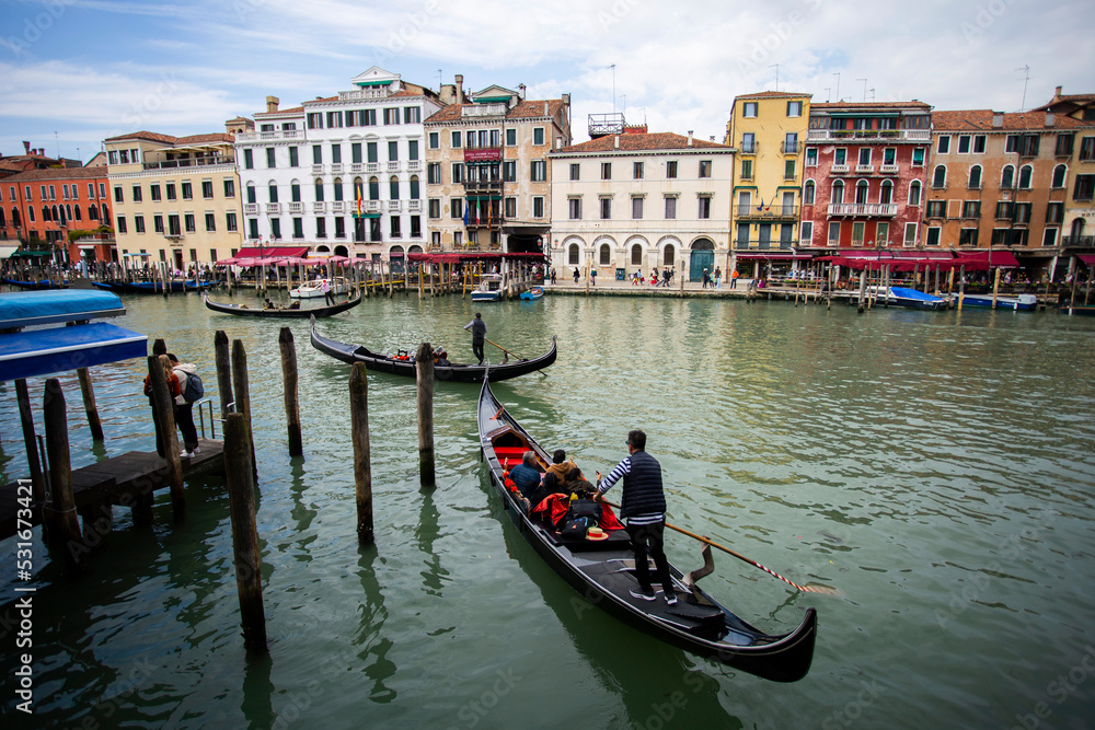 People enjoying gondola ride in Venice, Italy