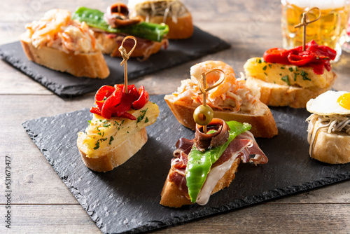 Assortment of Spanish pintxos on wooden table photo