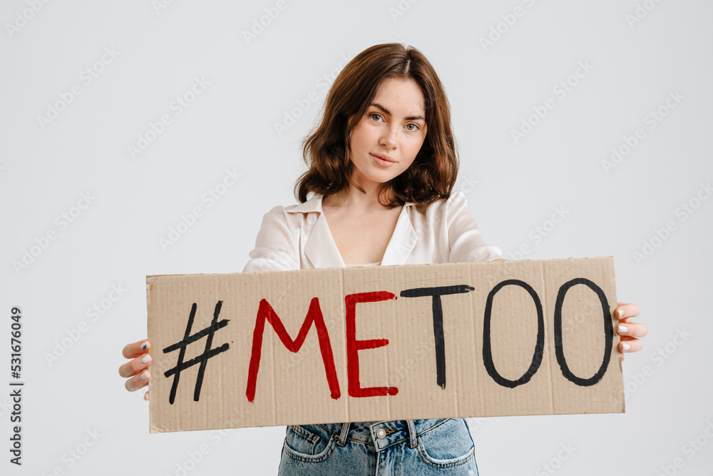 Young brunette woman holding placard with me too text Young brunette woman holding placard with me too text