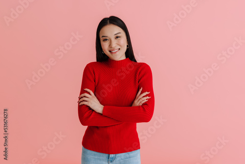 Asian young woman wearing sweater smiling and looking at camera