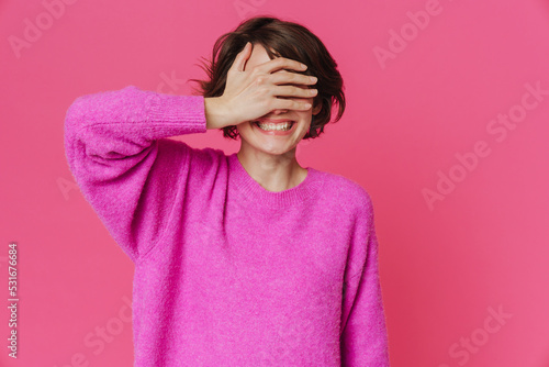 Young white woman wearing sweater smiling and looking aside © Drobot Dean