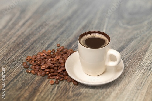 A cup with tasty aroma coffee on wooden table