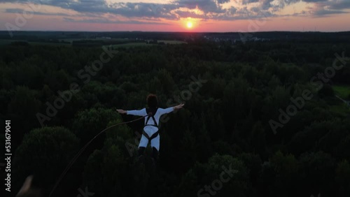a guy jumps from a tower, a man falls from a height, rope jumping