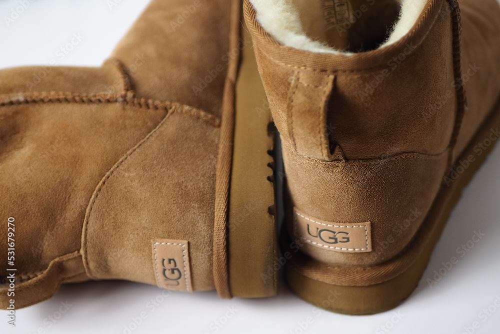 Brown Ugg boots on white background showing logo Stock Photo | Adobe Stock
