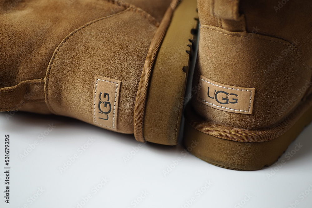 Brown Ugg boots on white background showing logo foto de Stock | Adobe Stock