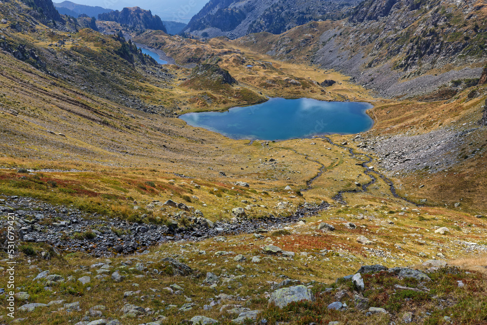 A creek leads to mountains lakes Claret and Longuet in La Pra mountains