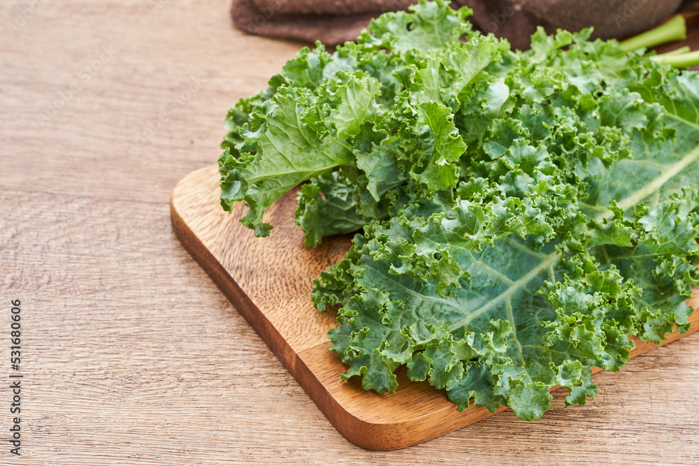 fresh green Kale leaves bunch leaf cabbage on wooden table background. green kale or leaf cabbage fresh green Kale leaves bunch leaf cabbage on wooden table background. green kale or leaf cabbage