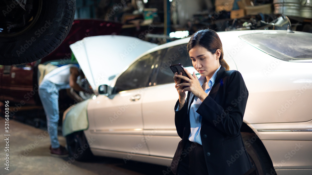 Serious asian young woman customer talking with owner and mechanic worker at car repair service and auto store shop. Serious asian young woman customer talking with owner and mechanic worker at car repair service and auto store shop.
