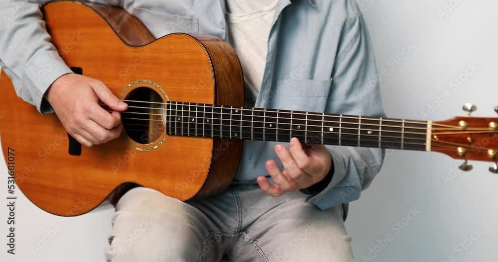 Guitarist man musician playing classic wooden guitar on white background, , relaxing with song and music. Practicing in playing guitar. Lifestyle concept.