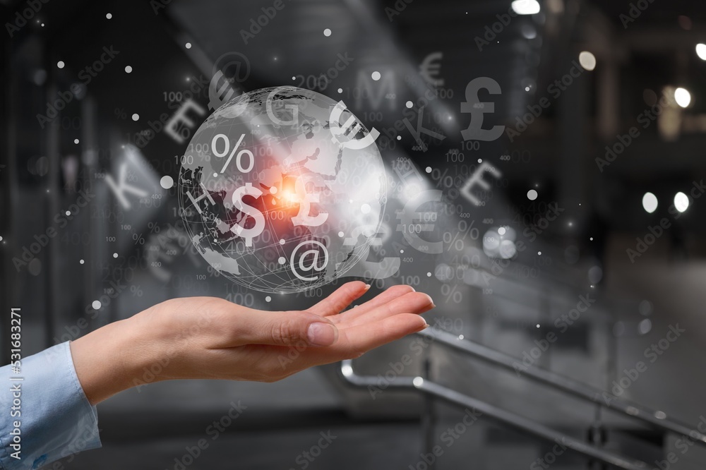 Businessman hand shows globe with map and currency. Businessman hand shows globe with map and currency.