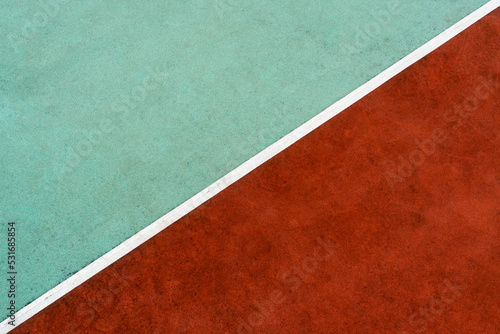 White line dividing rubber stadium surface into to colors