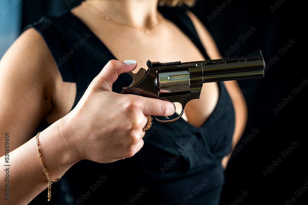 cropped photo of woman in dress with revolver inhand for shooting ...