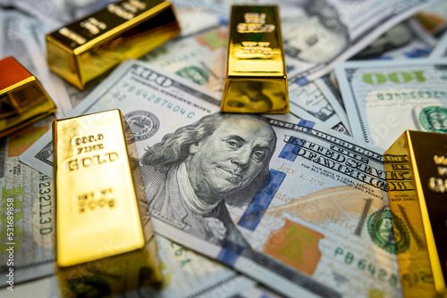  dollar banknote foreign currency and gold bullion prices isolated on dark background.